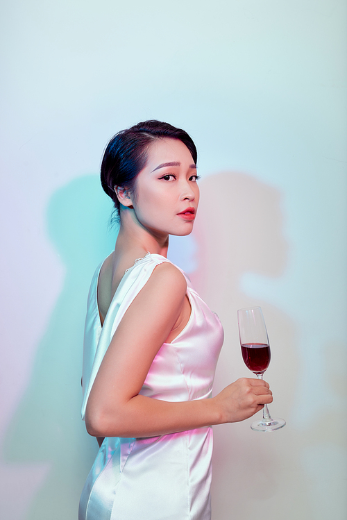 Party and holidays concept. Young asian woman  drinking cocktails and having fun