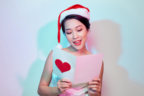 Image of happy beautiful female reading romantic postcard with big red heart, attractive woman got sensual greeting card and isolated on white background, Valentine day, love concept