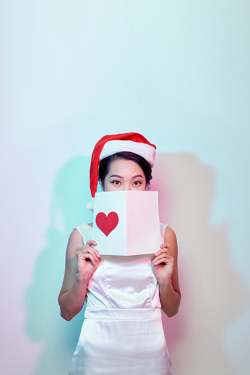 Image of happy beautiful female reading romantic postcard with big red heart, attractive woman got sensual greeting card and isolated on white background, Valentine day, love concept