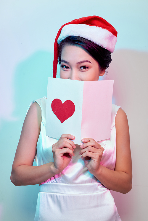 Image of happy beautiful female reading romantic postcard with big red heart, attractive woman got sensual greeting card and isolated on white background, Valentine day, love concept