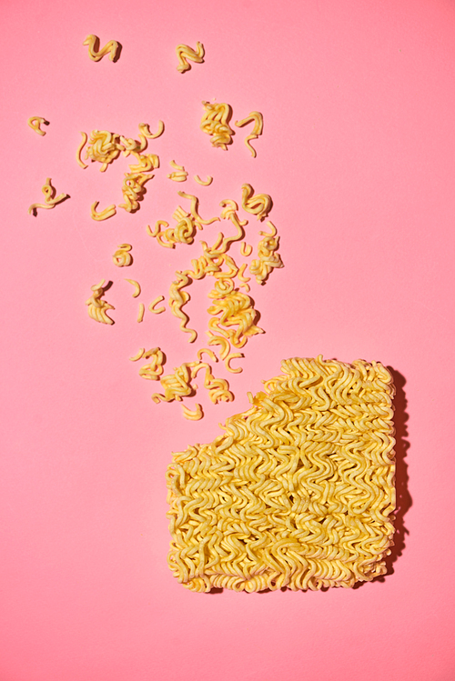 Cracked Instant noodles isolated on a pink background