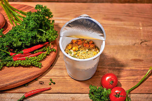 instant noodle, asian fast food, noodle cup on wooden background.