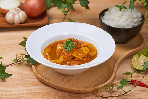 Chicken curry with spice on wooden background