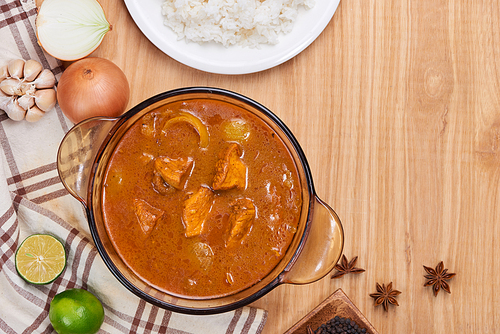 Chicken curry with spice on wooden background