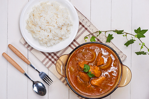 Chicken curry with spice on wooden background