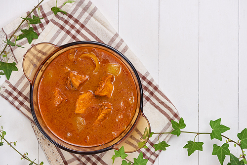 Chicken curry with spice on wooden background