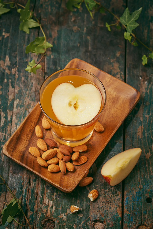 Hot drink of apple tea with cinnamon stick. Hot drink with apples for autumn or winter.