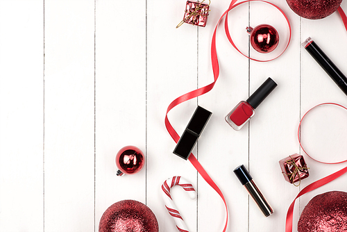 Flat lay of christmas ball, gift and cosmetic. Holiday Background. Beauty concept.