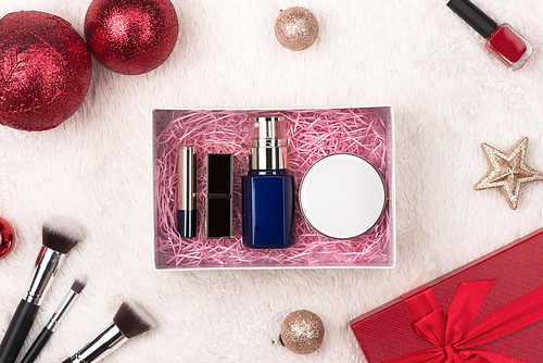 Winter holiday decoration with women cosmetics gift. Happy New Year. Merry Christmas.