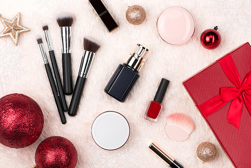 Flat lay of christmas ball, gift and cosmetic. Holiday Background. Beauty concept.