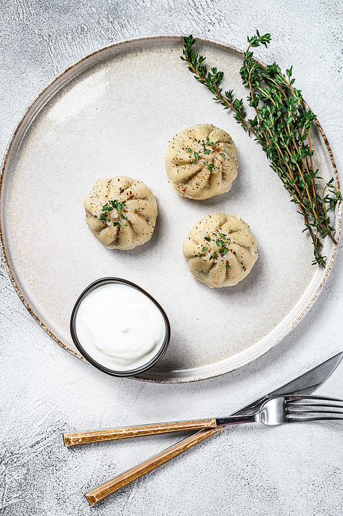 Asian Steamed Dumplings Manti with mince meat on a plate. White background. Top view.