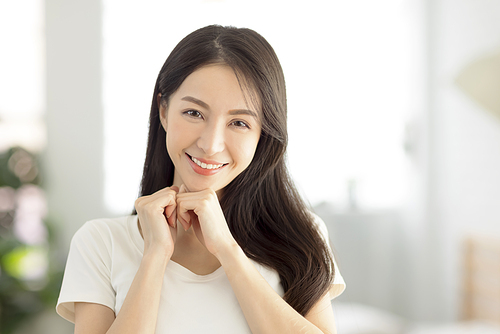 closeup smiling  young  woman face with clean  healthy skin