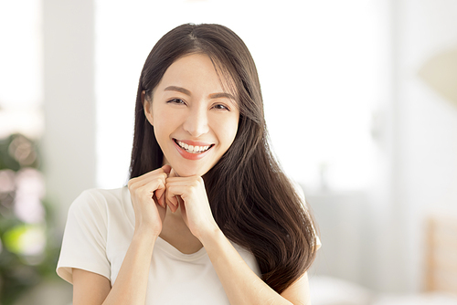 closeup smiling  young  woman face with clean and  healthy skin