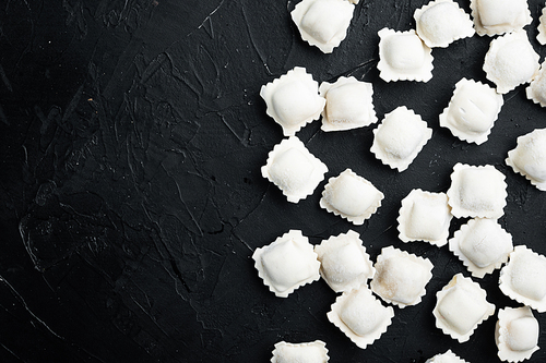 Frozen dumplings tortellini and ravioli set, on black background, top view flat lay , with copyspace  and space for text