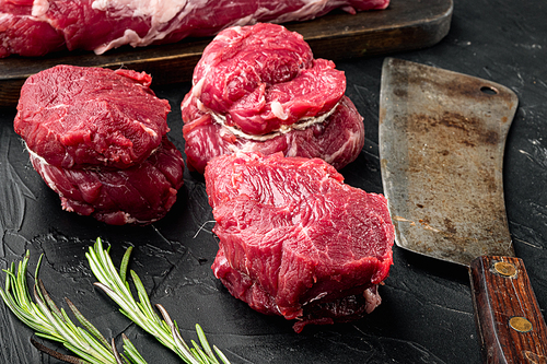 Raw beef fillet steaks with spices and whole marbled tenderloin cut set, on black stone background