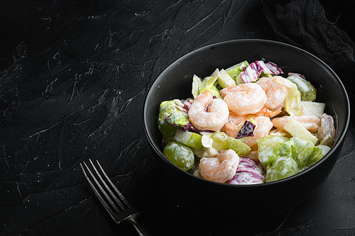 Organic picnic salad of fresh fruits and nuts: celery, fresh seafood set , with sauce apple and grape, on black stone background, with copy space for text