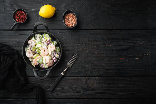 Traditional Waldorf salad with celery, shrimps set , with sauce apple and grape, on black wooden table, top view flat lay, with copy space for text