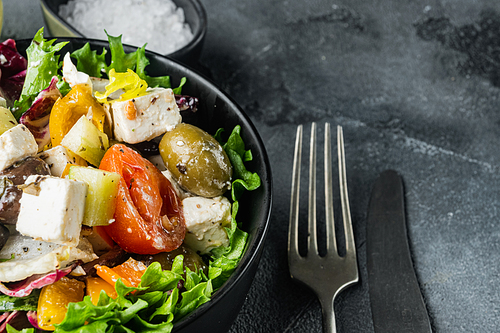 Greek salad with fresh vegetables, feta cheese and olives kalamati, on gray background