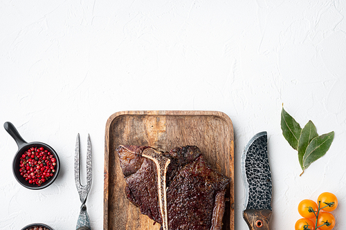 Roast t-bone or porterhouse beef meat Steak set, on wooden tray, top view flat lay, with copy space for text