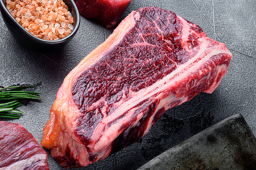 A raw fresh marbled beef steak set, on gray stone background, Club steak cut