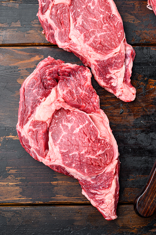 Rib eye steak fresh raw beef marbled prime meat ribeye set, on old dark  wooden table background, top view flat lay