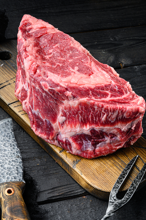 Raw fresh meat Ribeye steak entrecote of Black Angus Prime meat set, on black wooden table background