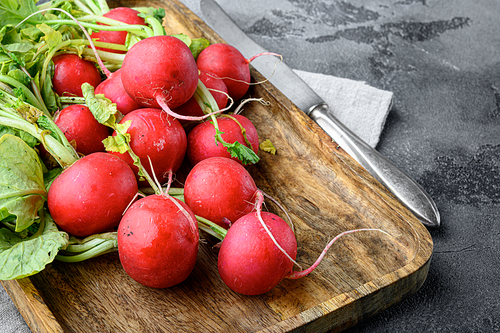 A bunch of juicy red radishes Healthy food set, on gray stone background, with copy space for text