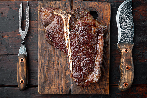 Grilled t bone steak set, on wooden serving board, top view flat lay
