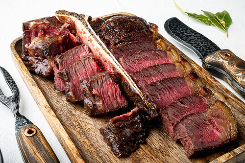 Barbecue dry aged Wagyu Porterhouse Steak sliced medium rare cooked marbled meat set, on white stone  background