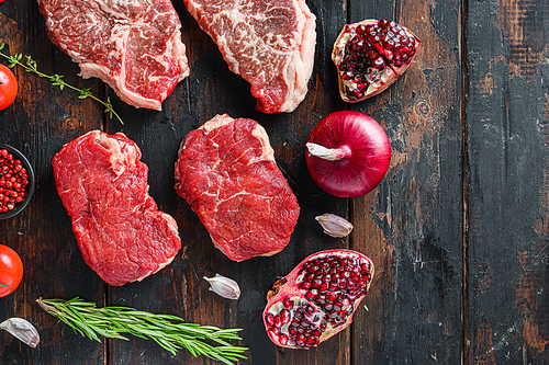 Raw organic alternative beef steakes rump,   with seasonings and herbs on old rustic dark wooden background, top view with space for text.