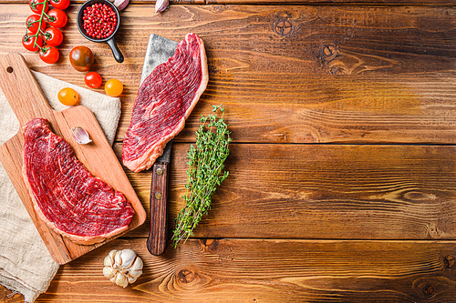 Set of picanha steaks over old american butcher cleaver with seasonings on wooden table. Top view with space for text