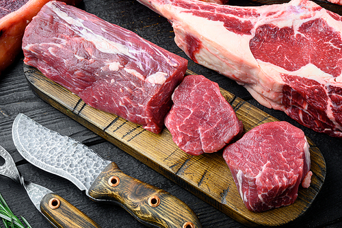 Tenderloin steak. Raw Beef Steak cut set, on black wooden table background