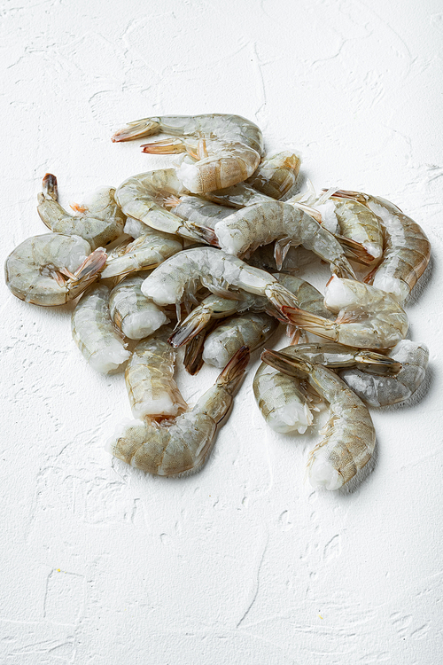 Raw shell on king prawns set, on white stone  surface, with copy space for text