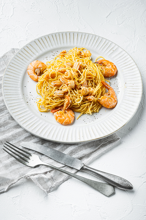 Rose pesto prawn pasta set, on plate, on white stone  surface