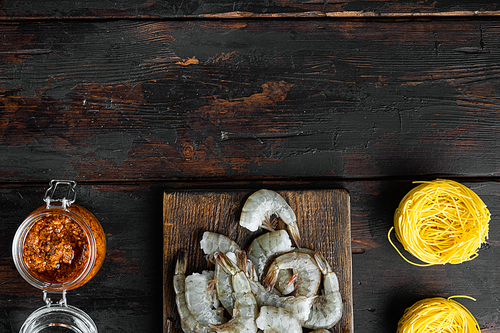 Traditional Italian dish. pasta with pesto ricotta parmesan and grilled seafood ingredients set, on old dark  wooden table, top view flat lay, with copy space for text