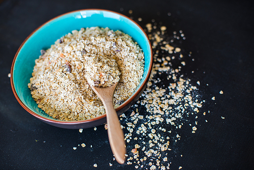 Healthy food concept with oatmeal on dark rustic background with copyspace