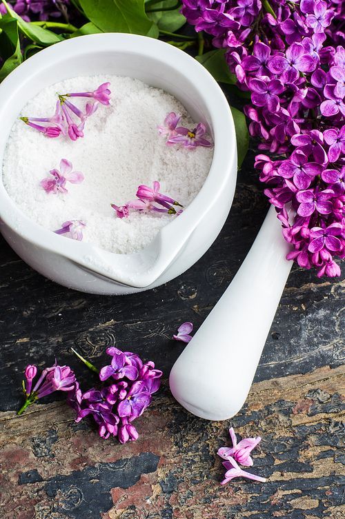 Spring spa concept with seasalt and bright purple lilac flowers
