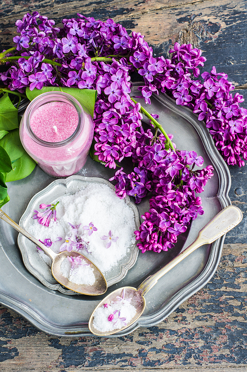 Spring spa concept with seasalt and bright purple lilac flowers