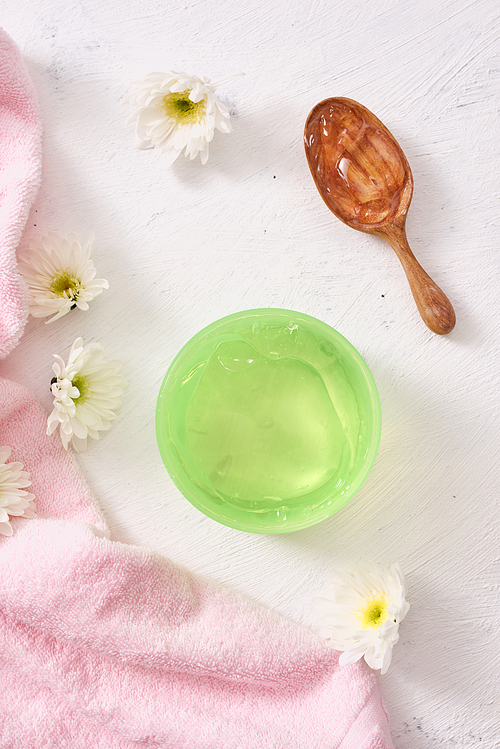 spa setting with cosmetic gel, leaves on white table background