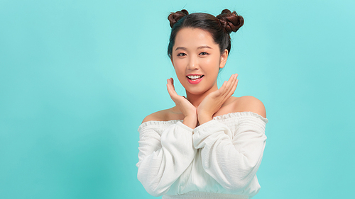 Portrait of beautiful woman posing gesture isolated on blue studio background