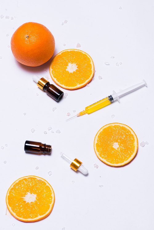 Branding mock-up. Natural essential oil, Cosmetic bottle containers with orange slices.