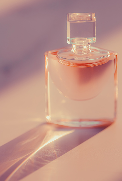 Pink fragrance bottle, perfumery as luxury beauty and cosmetic product.
