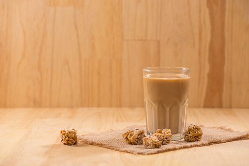 Coffee with milk on a wooden table.