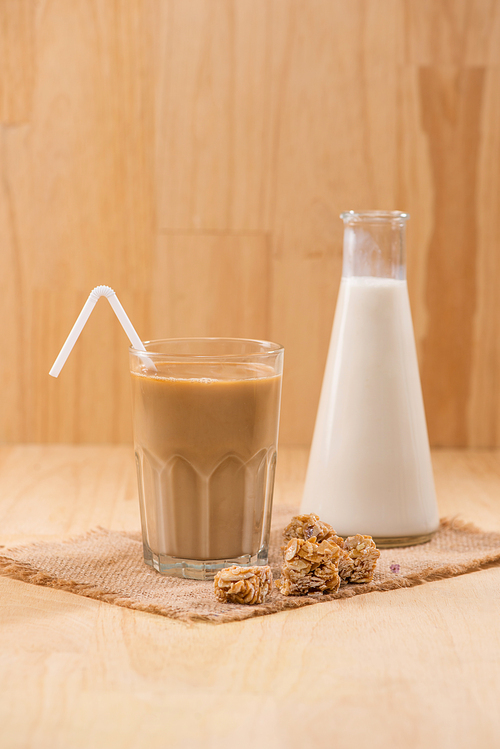 Coffee with milk on a wooden table.