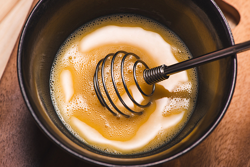 Prepare breakfast from eggs. Whipped eggs on wooden table.