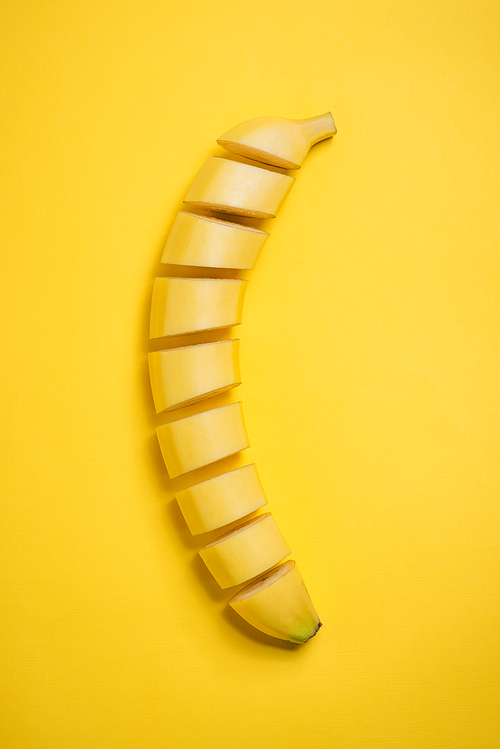 A banch of bananas with almonds and milk on wooden background.