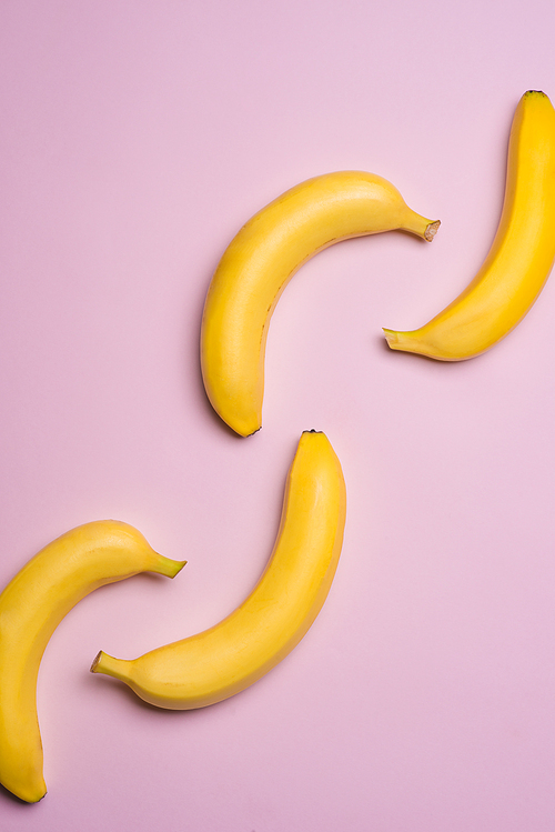 Top view. Group of bananas on pink background.