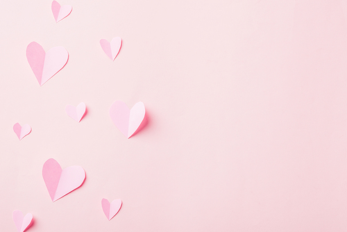 Valentines' day background. Pattern beautiful pink paper hearts cut composition greeting gift card isolated on pink background with copy space, Symbol of love Top View from above