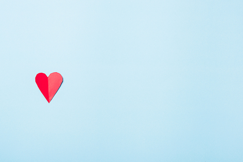 Valentines' day background. Beautiful red paper hearts cut composition greeting card isolated on blue background with copy space, Symbol of love Top View from above