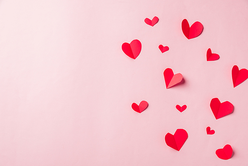 Valentines' day background. Pattern beautiful red paper hearts cut composition greeting gift card isolated on pink background with copy space, Symbol of love Top View from above